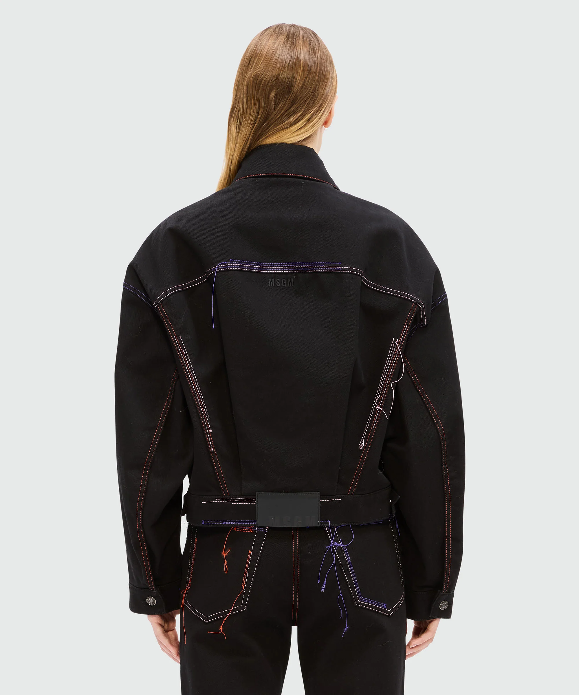 Black denim jacket with multi-colored stitching and threads - Image 3